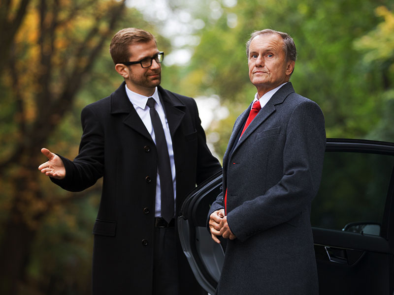 A security guard securing a senior corporate client